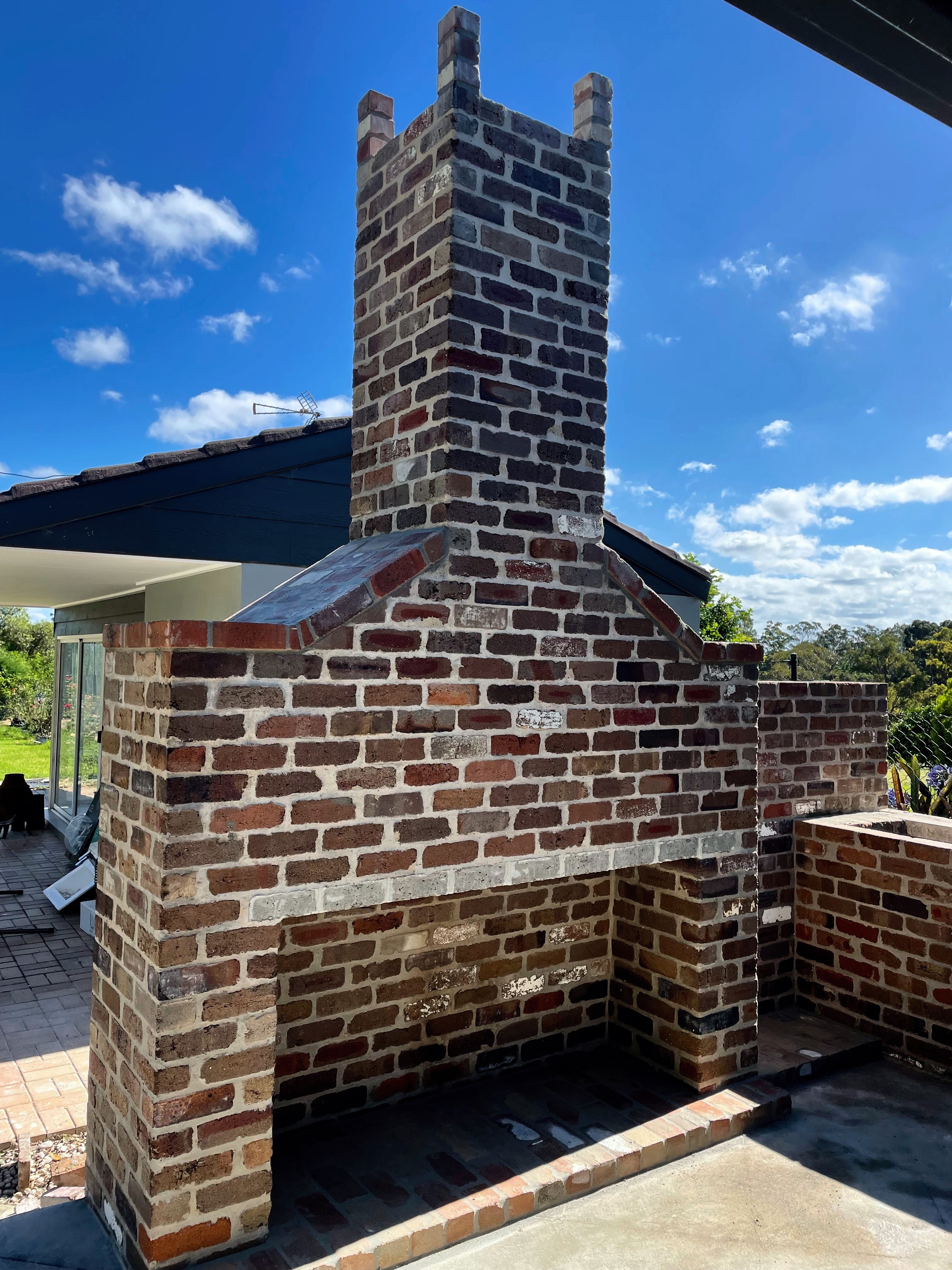A stonework garden chimney with cooking area and fire pit